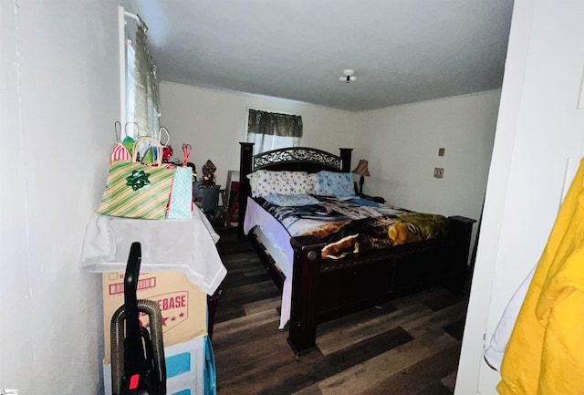 bedroom with dark hardwood / wood-style flooring