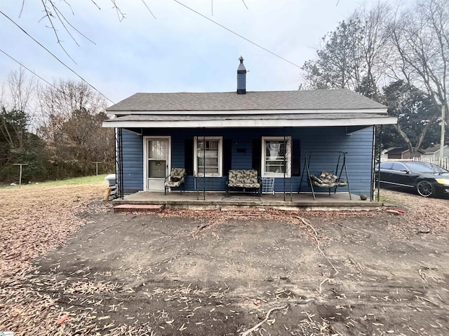 back of property featuring a porch