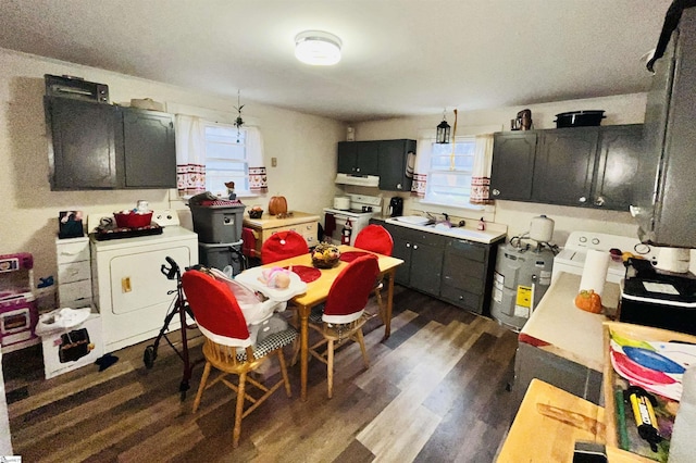 kitchen featuring dark hardwood / wood-style floors, sink, electric water heater, and white stove