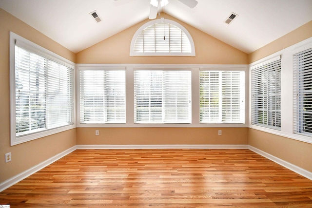 unfurnished sunroom with vaulted ceiling with beams, ceiling fan, and a wealth of natural light