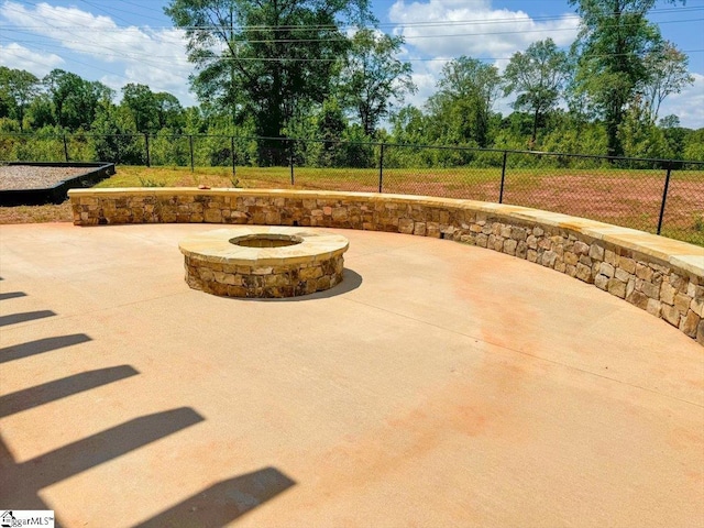 view of patio / terrace featuring an outdoor fire pit and fence