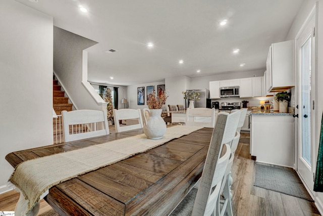 dining area featuring plenty of natural light and light hardwood / wood-style floors