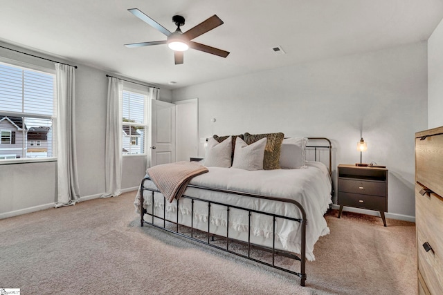 bedroom with ceiling fan and light colored carpet