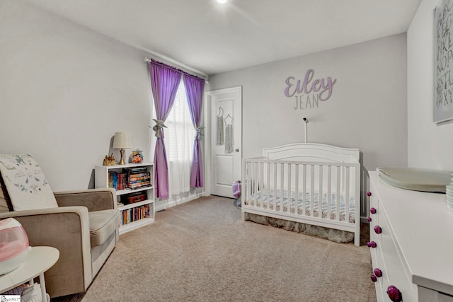 carpeted bedroom featuring a crib