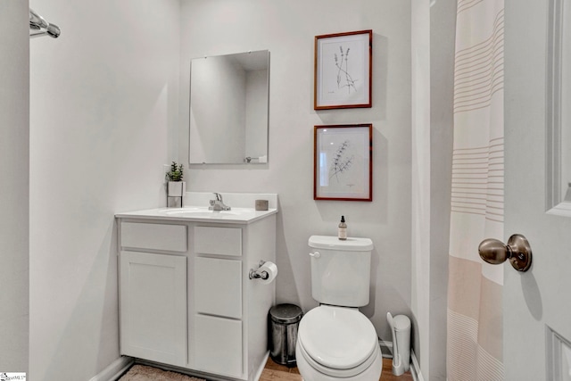 bathroom featuring hardwood / wood-style flooring, vanity, toilet, and a shower with shower curtain