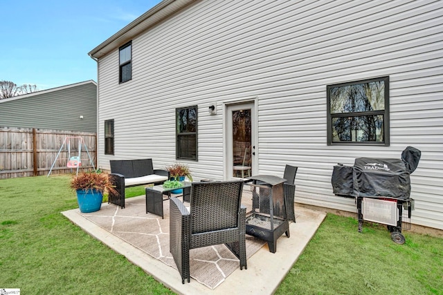 rear view of property with outdoor lounge area, a patio area, and a lawn