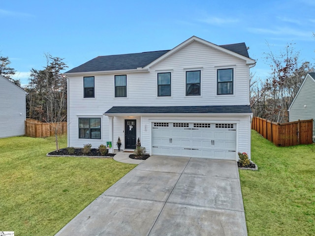 view of front of home featuring a front yard and a garage