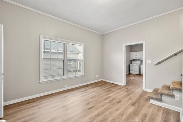 empty room with washer / dryer, light wood-type flooring, and ornamental molding