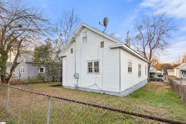 rear view of house with a lawn