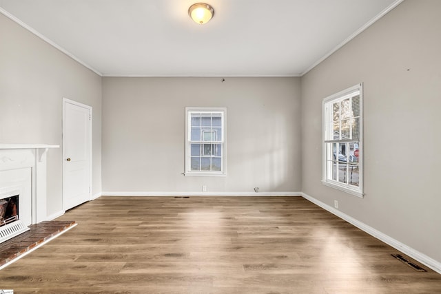 unfurnished living room with hardwood / wood-style floors and ornamental molding