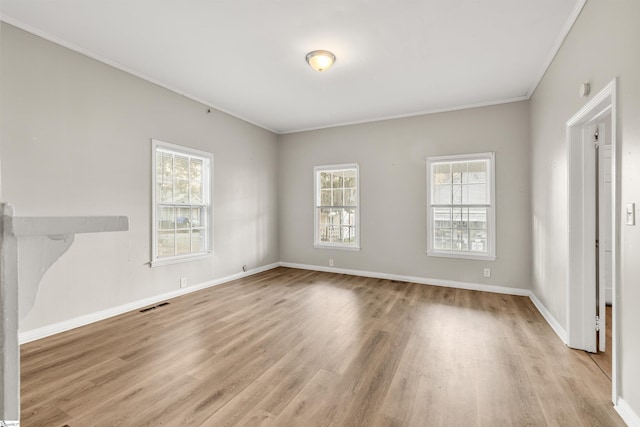 unfurnished room featuring light wood-type flooring and crown molding