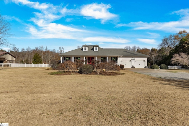 view of front of house with a front yard and a garage