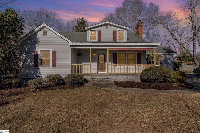 view of front of property featuring a yard and covered porch