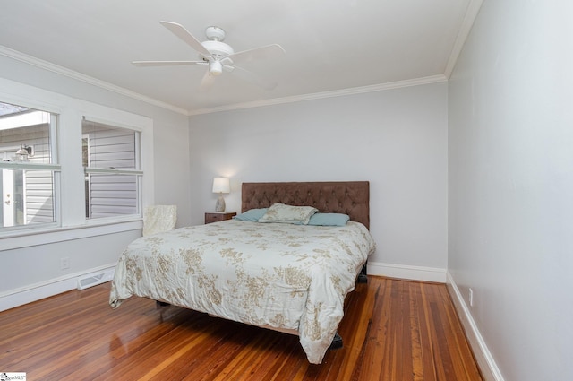 bedroom with ceiling fan, dark hardwood / wood-style floors, and ornamental molding