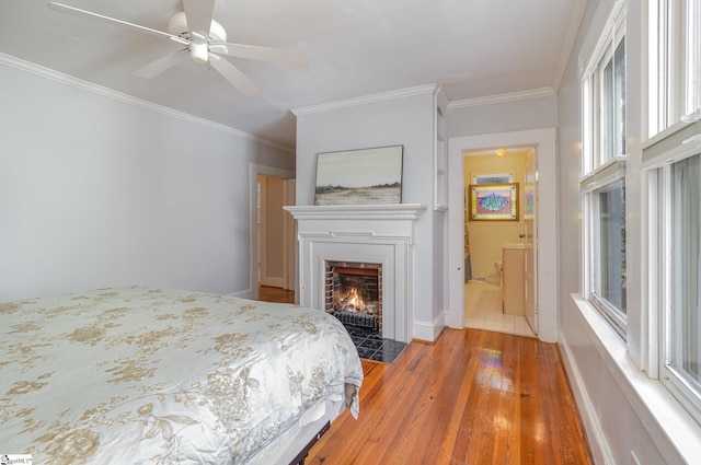 bedroom with hardwood / wood-style floors, ceiling fan, and ornamental molding