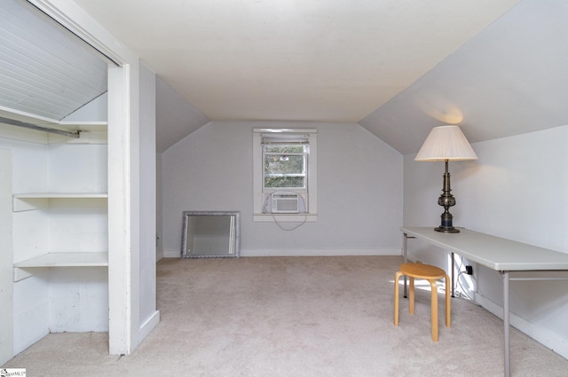 bonus room featuring built in shelves, light colored carpet, and lofted ceiling