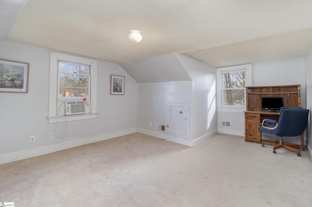 office space featuring light carpet, cooling unit, and lofted ceiling