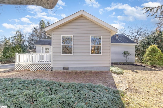 view of property exterior with a wooden deck