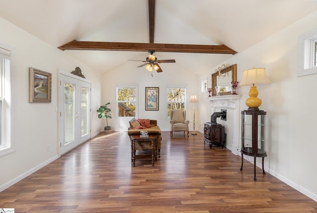 interior space with vaulted ceiling with beams, ceiling fan, dark hardwood / wood-style flooring, and french doors