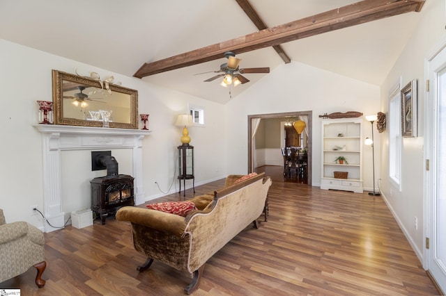 living room featuring beam ceiling, hardwood / wood-style flooring, and ceiling fan