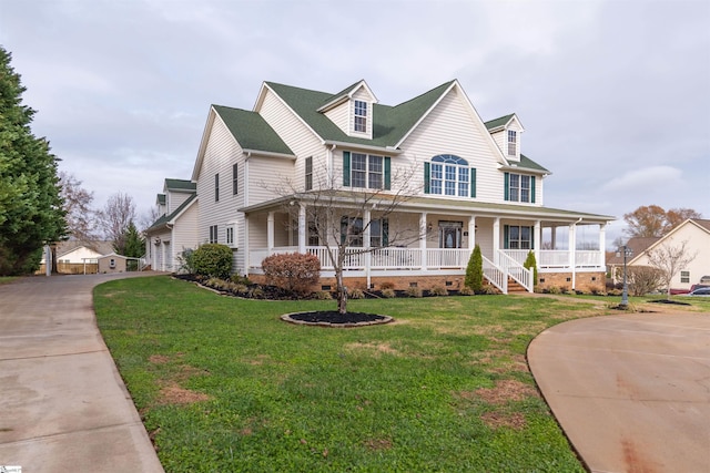 country-style home with a front lawn and covered porch