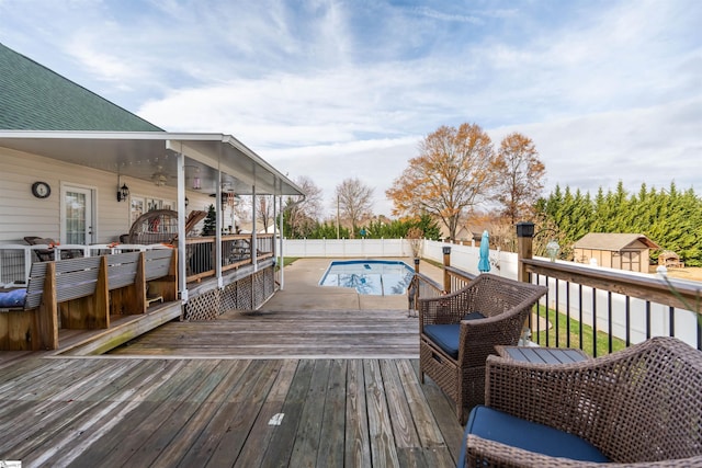 wooden terrace featuring a fenced in pool