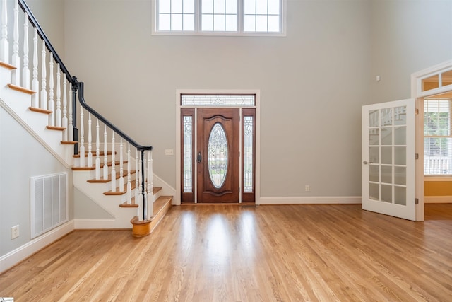 entryway featuring a high ceiling and light wood-type flooring