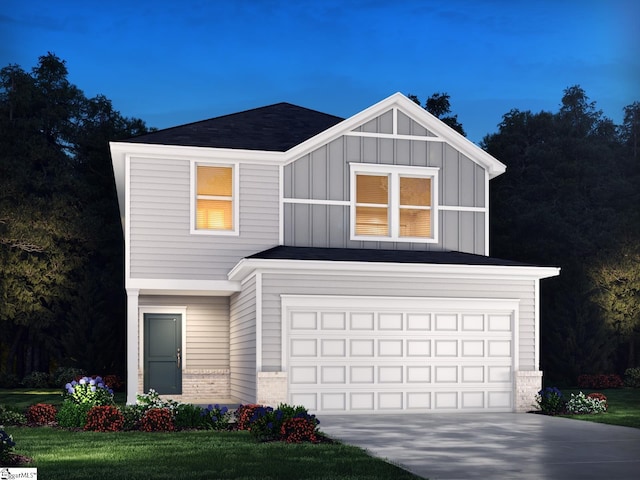 view of front facade with a garage and a front lawn