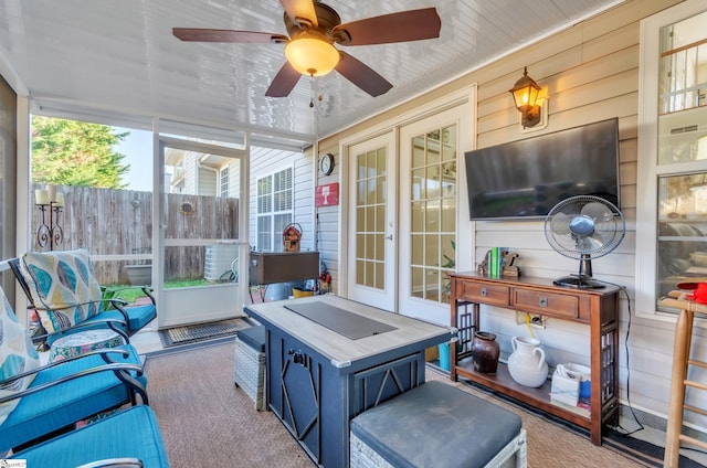 sunroom featuring ceiling fan and a healthy amount of sunlight