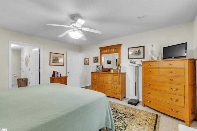 bedroom with ensuite bath and ceiling fan