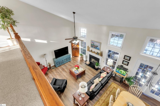 living room with hardwood / wood-style floors, high vaulted ceiling, and plenty of natural light