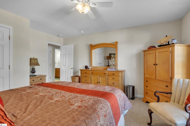 carpeted bedroom with a textured ceiling and ceiling fan