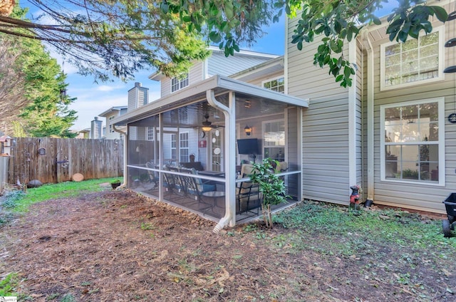 rear view of property with a sunroom