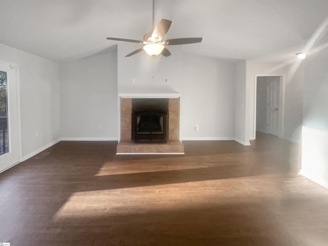 unfurnished living room featuring a fireplace, dark hardwood / wood-style floors, ceiling fan, and lofted ceiling