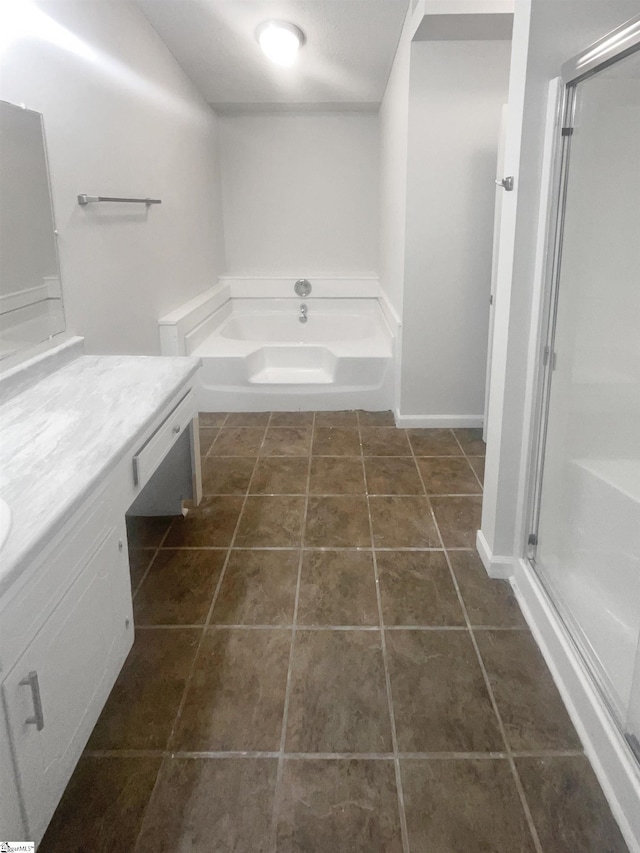 bathroom with tile patterned flooring, shower with separate bathtub, and vanity