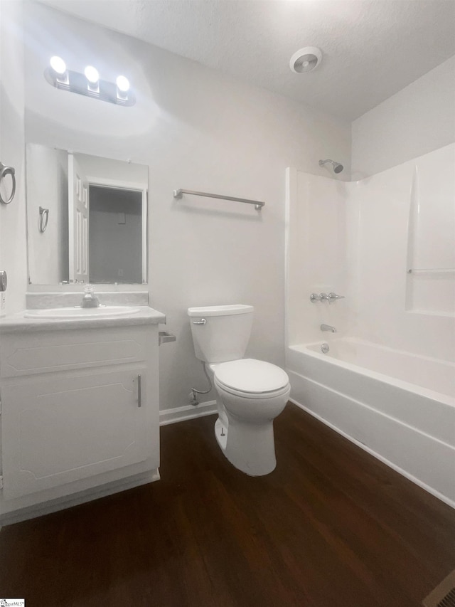 full bathroom with wood-type flooring, vanity, toilet, and shower / washtub combination