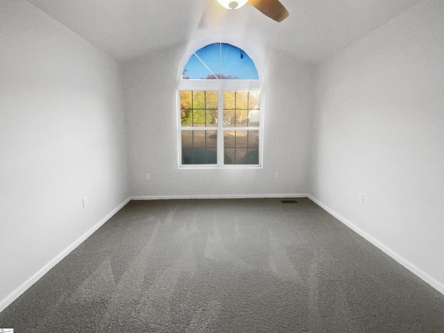 carpeted empty room featuring ceiling fan and lofted ceiling