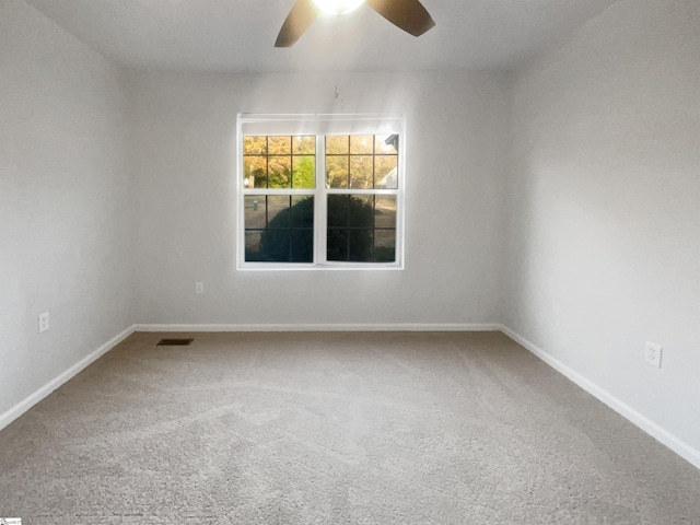 carpeted empty room featuring ceiling fan