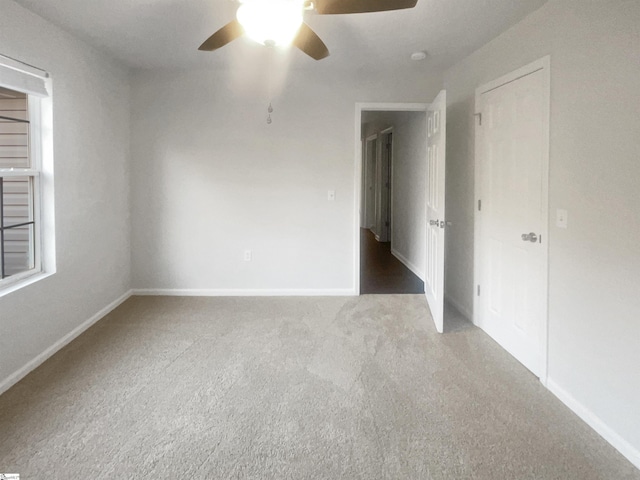 unfurnished room featuring carpet flooring and ceiling fan