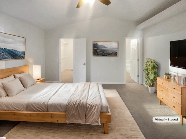 bedroom with ceiling fan, light colored carpet, a walk in closet, and ensuite bathroom