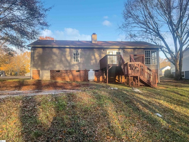 rear view of house featuring a yard