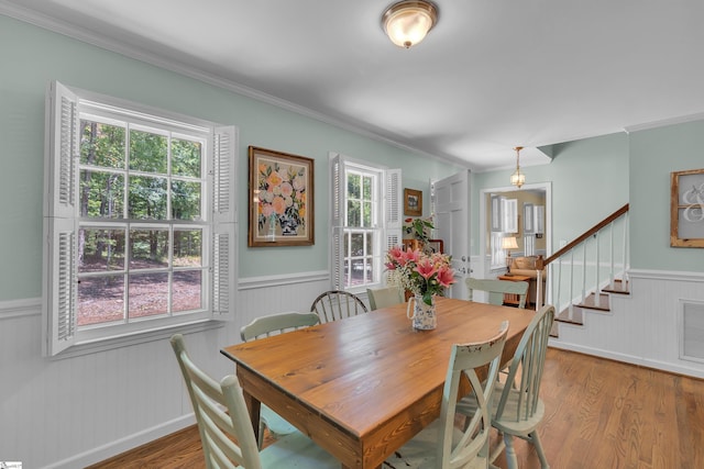 dining room featuring hardwood / wood-style flooring, plenty of natural light, and ornamental molding