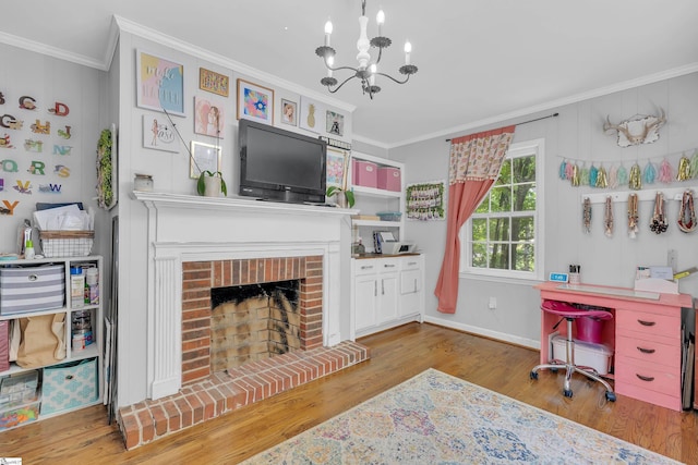 office area featuring a chandelier, crown molding, a fireplace, and light hardwood / wood-style floors