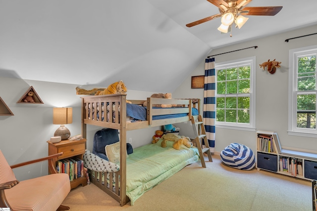 carpeted bedroom with ceiling fan and lofted ceiling