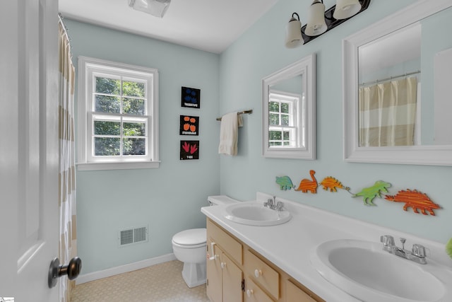 bathroom with tile patterned floors, vanity, and toilet