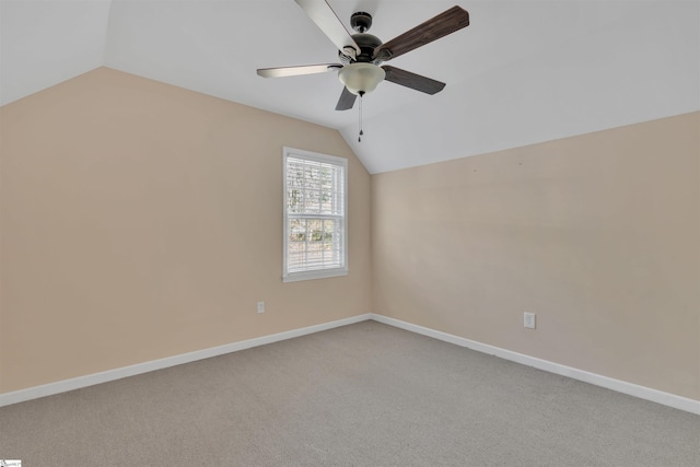 carpeted empty room with ceiling fan and lofted ceiling