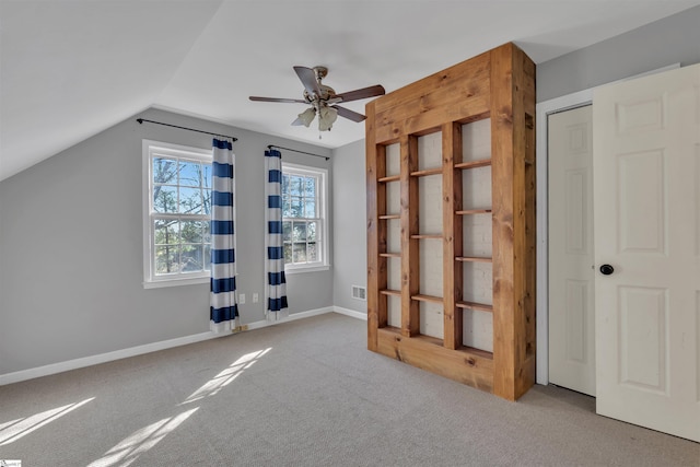 additional living space with carpet flooring, ceiling fan, and lofted ceiling