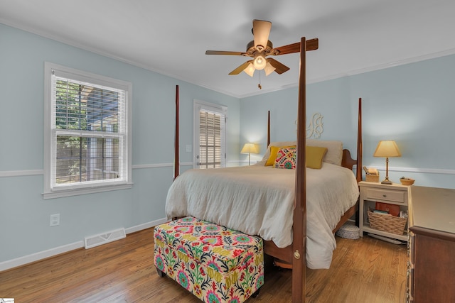 bedroom featuring light wood-type flooring, ceiling fan, and crown molding