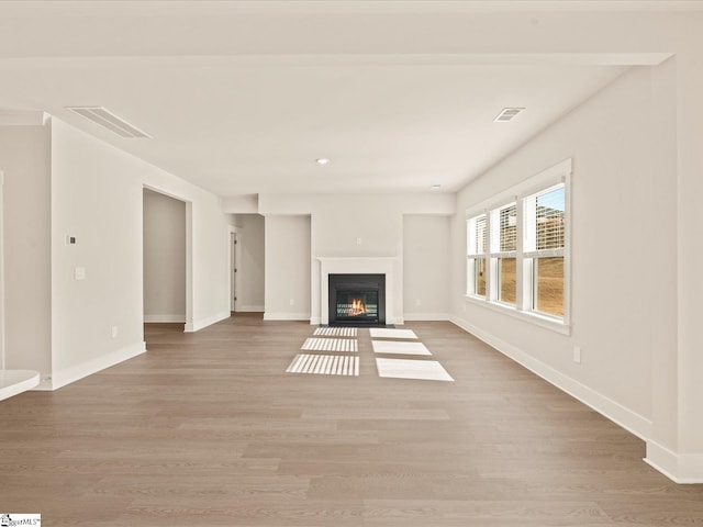 unfurnished living room with light hardwood / wood-style floors