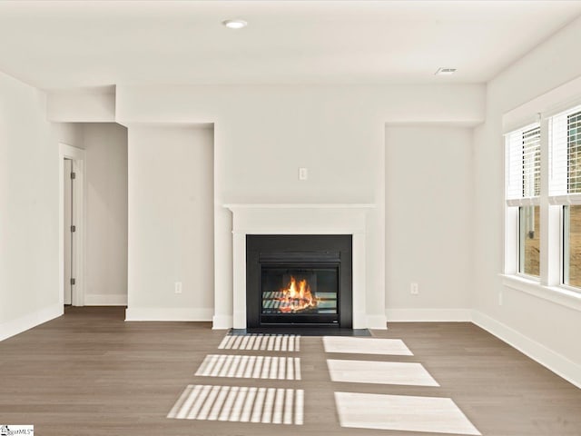 unfurnished living room featuring wood-type flooring